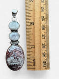 Making Waves Jewelry and Accessories sterling silver pendant with two moonstones and an oval crazy lace agate stone.