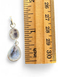 Making Waves Jewelry and Accessories sterling silver double moonstone drop pendant next to a wooden ruler for scale.