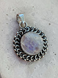 Making Waves Jewelry and Accessories round moonstone pendant with vintage silver scrollwork and bead detailing