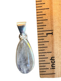 Making Waves Jewelry and Accessories teardrop moonstone pendant in polished 925 sterling silver next to a ruler
