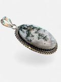Making Waves Jewelry and Accessories oval moss agate pendant in a decorative sterling silver wire-work bezel setting.