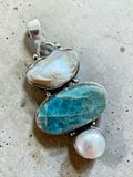 Making Waves Jewelry and Accessories artisan pendant with blue apatite, organic pearl, and mother-of-pearl in silver