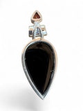 Making Waves Jewelry and Accessories sterling silver teardrop pendant with black onyx and a triangular garnet accent