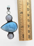 Making Waves Jewelry and Accessories pendant with blue opal and rose quartz in a sterling silver setting next to a ruler