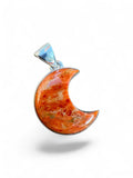 Making Waves Jewelry and Accessories crescent moon pendant with orange marbled gemstone in a sterling silver setting.