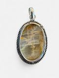 Making Waves Jewelry and Accessories oval gemstone pendant with a silver-tone twisted rope border on a white background