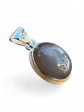 Making Waves Jewelry and Accessories oval grey moonstone pendant in a polished 925 sterling silver bezel setting.