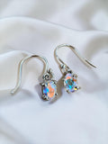 Making Waves Jewelry and Accessories oval iridescent drop earrings in 925 sterling silver on a white satin background