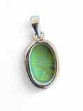 Making Waves Jewelry and Accessories oval doublet opal pendant in a polished sterling silver bezel setting.