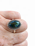 Making Waves Jewelry and Accessories oval dark opal ring in sterling silver with a twisted rope border on a finger