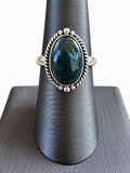 Making Waves Jewelry and Accessories sterling silver oval ring with a dark opal stone and twisted rope border detail.
