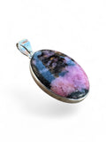 Making Waves Jewelry and Accessories oval rhodonite pendant in a polished 925 sterling silver bezel setting