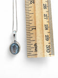 Making Waves Jewelry and Accessories oval iridescent gemstone pendant necklace on a sterling silver box chain with ruler