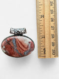 Making Waves Jewelry and Accessories oval pendant with terracotta and grey natural stone in a silver filigree setting