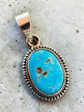 Making Waves Jewelry and Accessories oval turquoise pendant in 925 sterling silver with a beaded border detail.