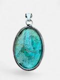 Making Waves Jewelry and Accessories oval turquoise pendant with natural matrix patterns in a sterling silver bezel