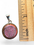 Making Waves Jewelry and Accessories round pink druzy stone pendant in a sterling silver bezel next to a ruler