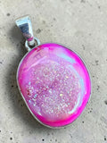 Making Waves Jewelry and Accessories hot pink druzy oval pendant in a polished 925 sterling silver setting.