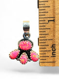 Making Waves Jewelry and Accessories sterling silver pendant with four hot pink opals next to a one-inch ruler