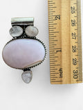 Making Waves Jewelry and Accessories sterling silver pendant with a large oval pink opal and three moonstone accents.