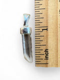 Making Waves Jewelry and Accessories clear quartz crystal point pendant in sterling silver next to a ruler