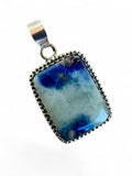 Making Waves Jewelry and Accessories rectangular pendant featuring a blue and grey stone in a beaded sterling silver bezel