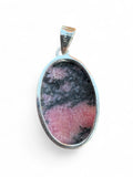 Making Waves Jewelry and Accessories oval rhodonite pendant in a 925 sterling silver bezel with pink and black stone