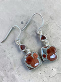 Making Waves Jewelry and Accessories sterling silver drop earrings with orbicular rhyolite and red garnet stones.