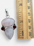 Making Waves Jewelry and Accessories sterling silver pendant with rose quartz and garnet stones next to a ruler.