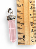 Making Waves Jewelry and Accessories rose quartz crystal point pendant with silver beaded cap next to a ruler