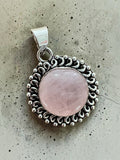 Making Waves Jewelry and Accessories round rose quartz pendant in an intricate vintage-style sterling silver frame.