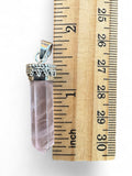 Making Waves Jewelry and Accessories rose quartz crystal point pendant with silver cap measured against a wooden ruler