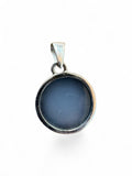 Making Waves Jewelry and Accessories round pendant featuring a smooth grey stone set in a 925 sterling silver bezel