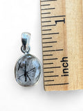 Making Waves Jewelry and Accessories oval rutilated quartz pendant with black tourmaline inclusions in sterling silver.