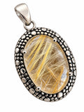 Making Waves Jewelry and Accessories oval rutilated quartz pendant in a textured sterling silver beaded setting.