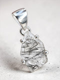 Making Waves Jewelry and Accessories rutilated quartz pendant with black needle inclusions in a sterling silver setting.