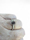 Making Waves Jewelry and Accessories oval rutilated quartz ring in sterling silver worn on a finger