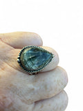 Making Waves Jewelry and Accessories teardrop Seraphinite ring in sterling silver with rope border on a finger