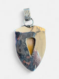 Back view of a Making Waves Jewelry and Accessories shield pendant featuring polished Mookaite Jasper in sterling silver