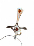 Making Waves Jewelry and Accessories silver-tone cross pendant necklace with two teardrop amber-colored stones.