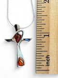 Making Waves Jewelry and Accessories silver cross pendant necklace with two teardrop amber stones next to a ruler