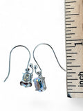 Making Waves Jewelry and Accessories sterling silver oval drop earrings with iridescent stones next to a ruler