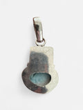 Back view of a Making Waves Jewelry and Accessories sterling silver pendant showing the smooth metal casing