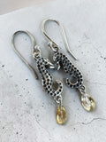 Making Waves Jewelry and Accessories silver seahorse drop earrings with yellow teardrop crystal charms on hook backs.