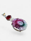 Making Waves Jewelry and Accessories solar quartz and red gemstone pendant in sterling silver setting.