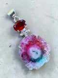 Making Waves Jewelry and Accessories solar quartz and red gemstone pendant in sterling silver setting.