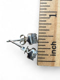 Making Waves Jewelry and Accessories square black druzy stud earrings with silver settings next to a ruler for scale.