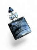 Making Waves Jewelry and Accessories square fossil stone pendant in sterling silver with a black triangular gemstone.