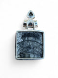 Making Waves Jewelry and Accessories square fossil stone pendant in sterling silver with a black triangular accent.