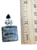 Making Waves Jewelry and Accessories square fossil stone pendant in sterling silver with a black triangular gemstone.